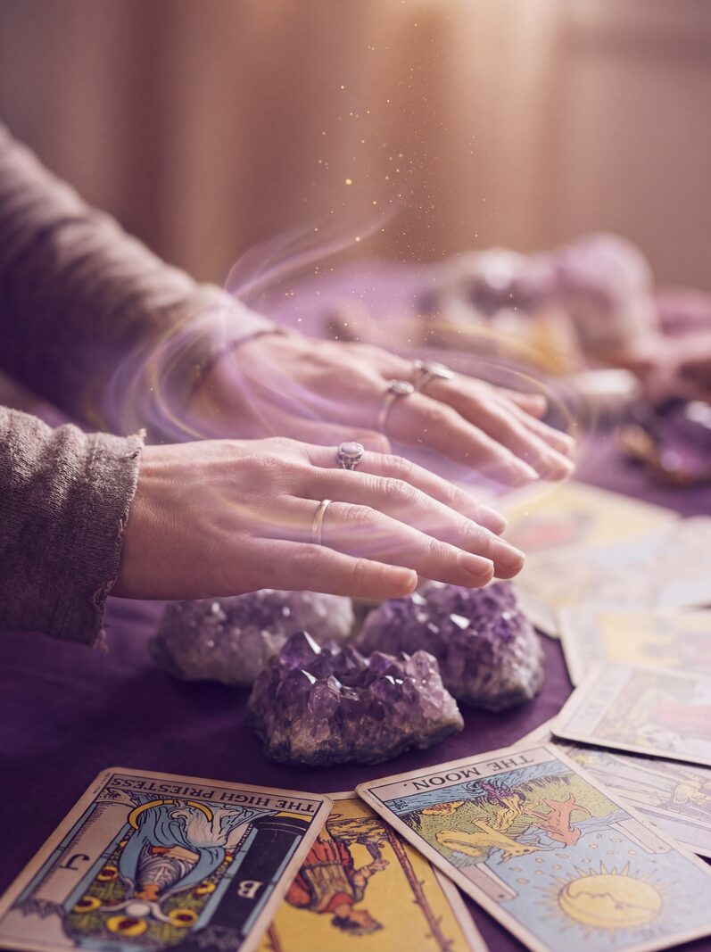 Hands exploring intuitive games at a candlelit table